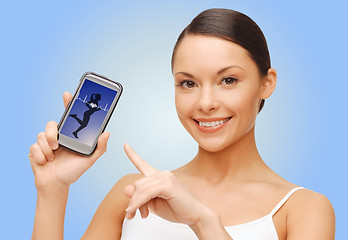 Image showing happy woman showing smartphone blank screen