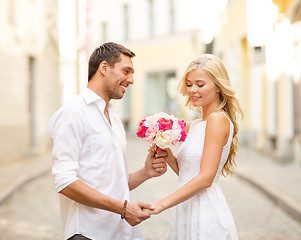 Image showing couple with flowers in the city