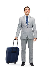 Image showing happy businessman in suit with travel bag