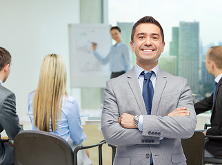 Image showing happy smiling business team over office room