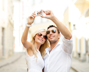 Image showing travelling couple taking photo picture with camera