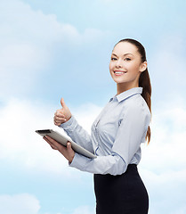 Image showing smiling woman looking at tablet pc computer