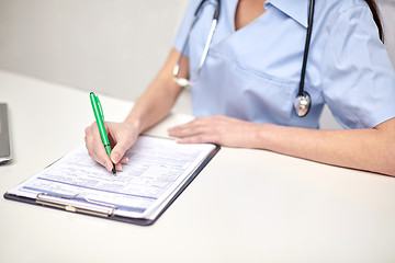 Image showing close up of female doctor writing prescription