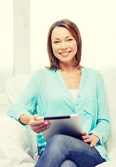 Image showing smiling woman with tablet pc computer at home