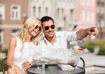 Image showing couple with map in cafe