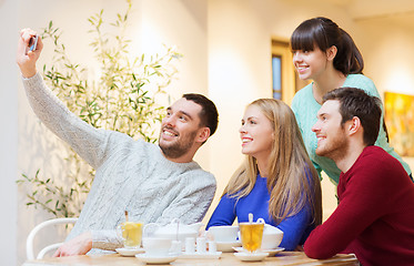 Image showing group of friends taking selfie with smartphone