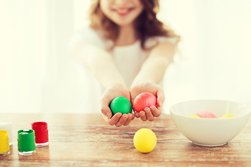 Image showing close up of girl holding colored eggs