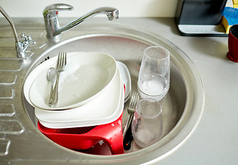 Image showing close up of dirty dishes washing in kitchen sink