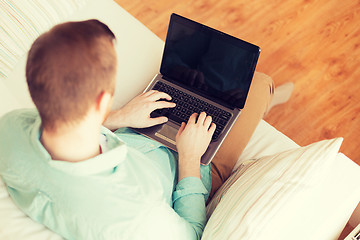 Image showing close up of man working with laptop at home