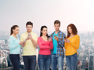 Image showing group of serious teenagers with smartphones