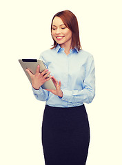 Image showing smiling woman looking at tablet pc