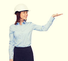 Image showing young smiling businesswoman in white helmet