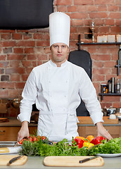 Image showing happy male chef cook with vegetables in kitchen