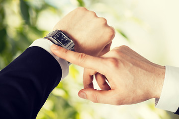 Image showing man looking at wristwatch