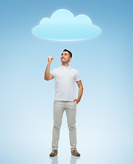 Image showing smiling man pointing finger up to cloud