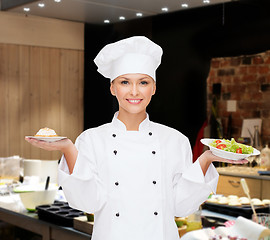 Image showing smiling female chef with salad and cake on plates