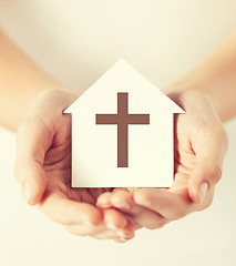 Image showing hands holding paper house with cross symbol