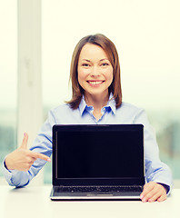 Image showing businesswoman with blank black laptop screen