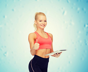 Image showing smiling sporty woman with tablet pc computer