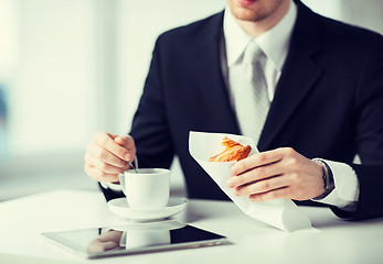 Image showing man with tablet pc and cup of coffee