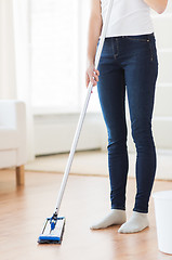 Image showing close up of woman with mop cleaning floor at home