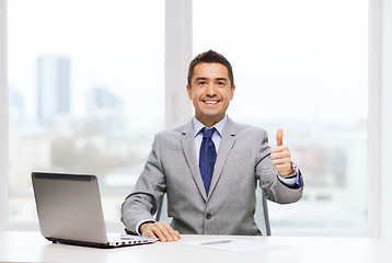 Image showing businessman working with laptop in office