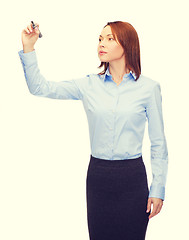 Image showing businesswoman writing something in air with marker