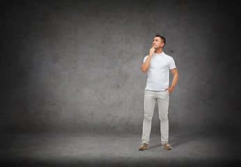 Image showing smiling man with looking up and thinking