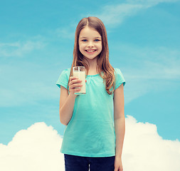 Image showing smiling little girl with glass of milk