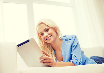 Image showing smiling woman with tablet pc computer at home