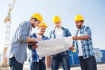 Image showing group of builders with tablet pc and blueprint