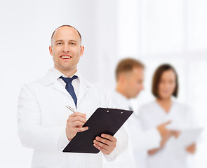 Image showing smiling male doctor with clipboard