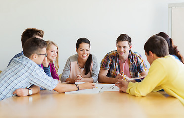 Image showing group of smiling students with blueprint