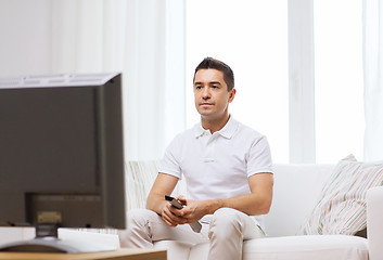 Image showing man with remote control watching tv