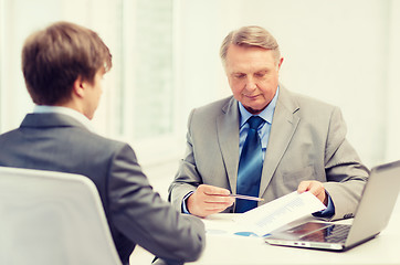 Image showing older man and young man having meeting in office