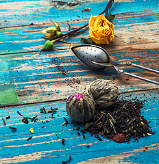 Image showing Tea leaves for brewing,tea spoon and dried yellow rose