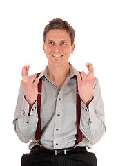 Image showing Smiling man crossing fingers