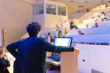 Image showing Speaker giving talk on podium at Business Conference.