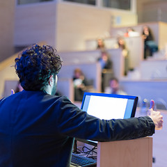 Image showing Speaker giving talk on podium at Business Conference.