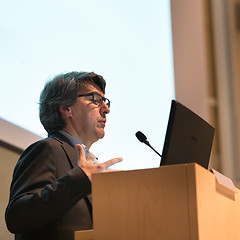 Image showing Speaker giving talk on podium at Business Conference.