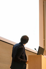 Image showing Speaker giving talk on podium at Business Conference.