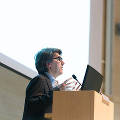Image showing Speaker giving talk on podium at Business Conference.