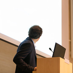 Image showing Speaker giving talk on podium at Business Conference.