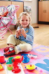 Image showing Cute girl playing with toys