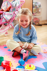 Image showing Cute girl playing with toys
