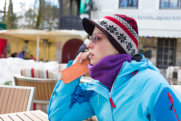 Image showing Woman in ski resort using smartphone.