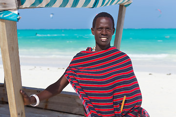 Image showing Traditonaly dressed black man on beach. 