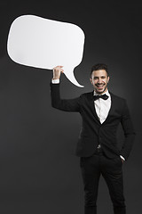 Image showing Latino young man holding a speach balloon