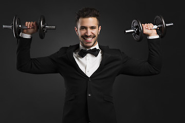 Image showing Young man lifting weights