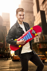 Image showing Young man with a skateboard